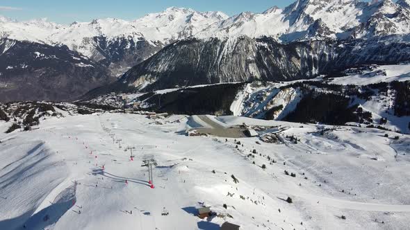 Aerial View of the Alps Mountains in France. Mountain Tops Covered in Snow. Alpine Ski Facilities