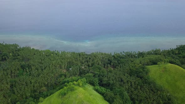 Aerial View of Tropical Blue Ocean Bay and Green Hills