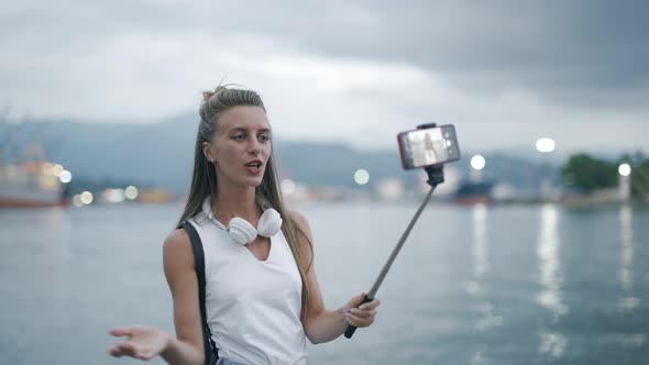 A Young Attractive Woman Blogger or Vlogger is Recording Content for Channel and Looking at alt