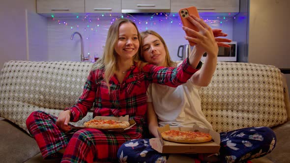 Beautiful Cheerful Girls in Pajamas Speaking with Their Friends By Video Call. Stylish Young Women