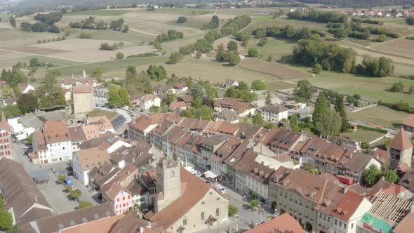 Aerial low overflight of Avenches main street and Roman arena. Vaud - Switzerland alt