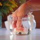 Hand taking false teeth out of glass of water - VideoHive Item for Sale