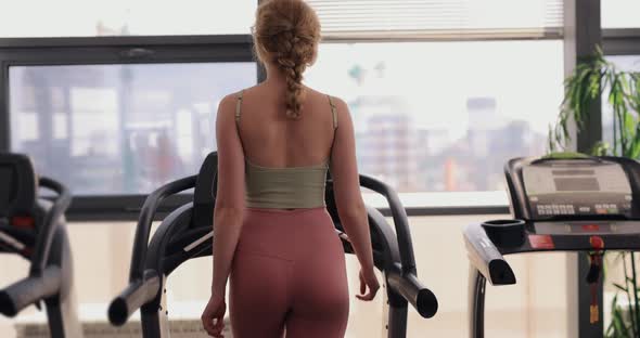 Woman Walking on a Treadmill in Gym