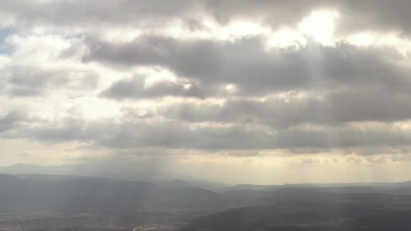Clouds and sun rays above the valley 4K drone video alt