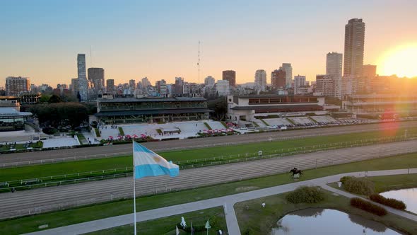 Aerial pan shot overlooking at Hipodromo Argentino de Palermo horse racing course with Argentina fla alt