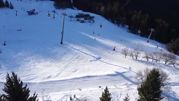 Aerial Winter Scene of Alpine Snowy Mountain Peaks and Dark Spruce Forest in Snow