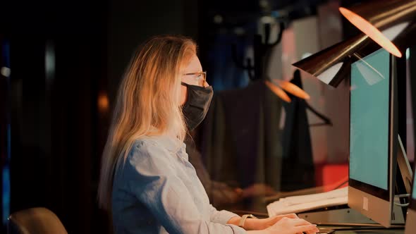 Girl In Face Mask Working In Office. Distance Working Webcam. Businesswoman In Face Mask. alt