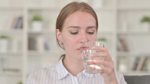 Portrait of Beautiful Young Woman Drinking Water alt