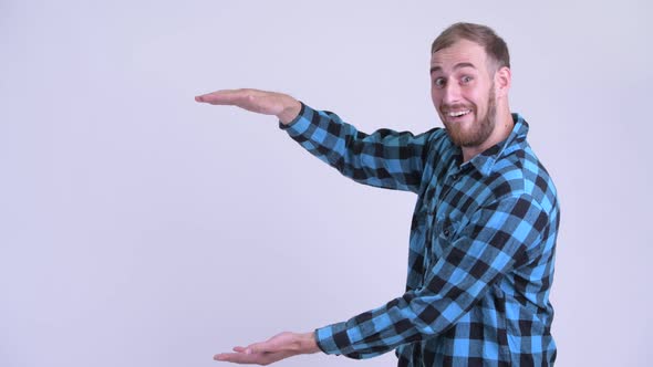 Happy Bearded Hipster Man Snapping Fingers and Looking Surprised alt