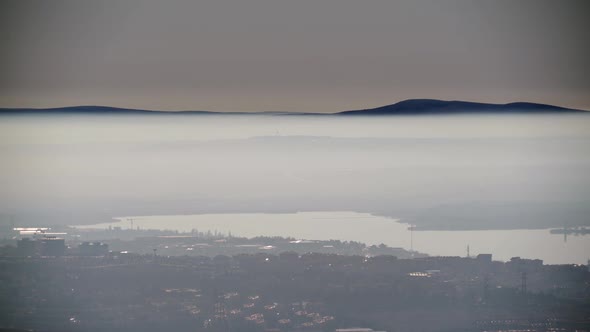 8K Houses of City By The Lake Under Fog