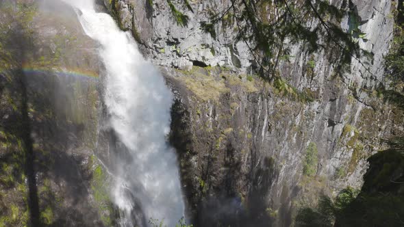 Waterfall Rushing Down a Rocky Canyon in the Canadian Mountains alt