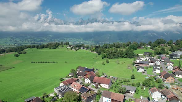 Aerial View of Liechtenstein with Houses on Green Fields in Alps Mountain Valley alt