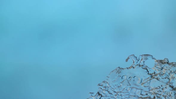 Melting Ice Closeup on Blue Background
