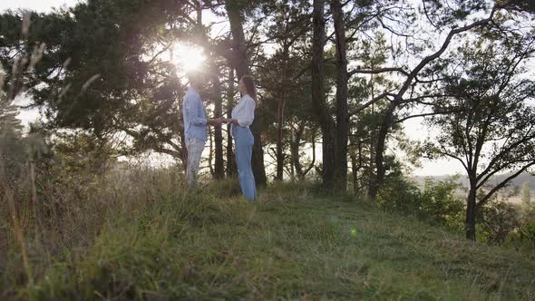 Closeup of Man and a Wooman That Joining Hands Together on Nature Background alt