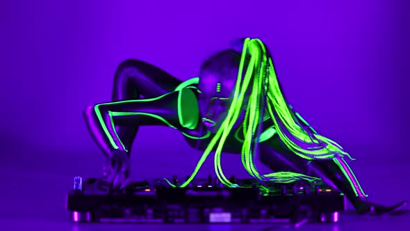 Wide Shot Cyborg Woman Dancing on DJ Set in Ultraviolet Light Looking at Camera alt