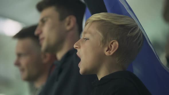 Child and Adult Fans Waving French Flag, Cheering for Football Team at Stadium alt