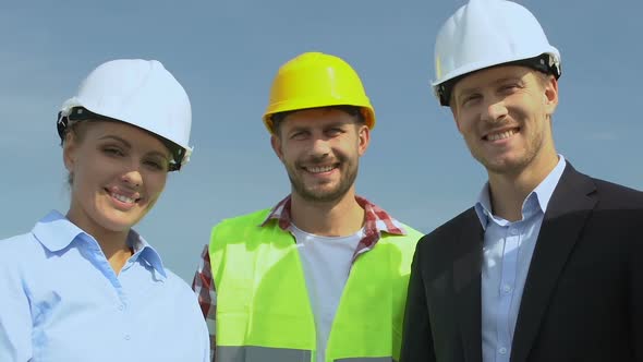 Professional Engineer, Architect and Head Builder in Helmets Smiling on Camera