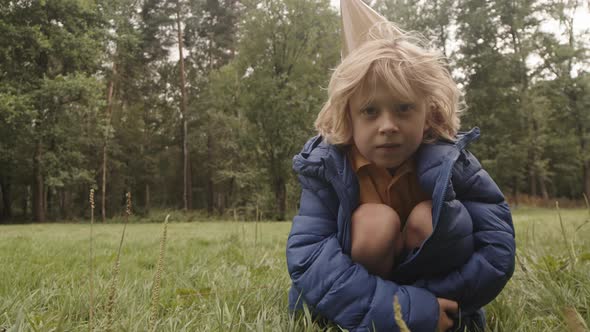 Boy Wearing Jacket in Park alt