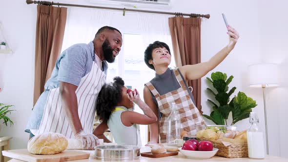 Love moment. Happy family take a selfie by smartphone at home in the kitchen