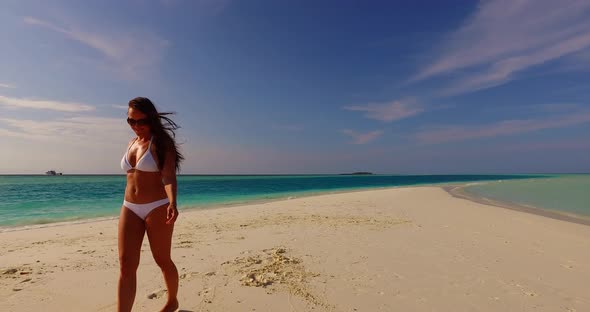 Beautiful beauty model relaxing in the sun at the beach on paradise white sand and blue  alt