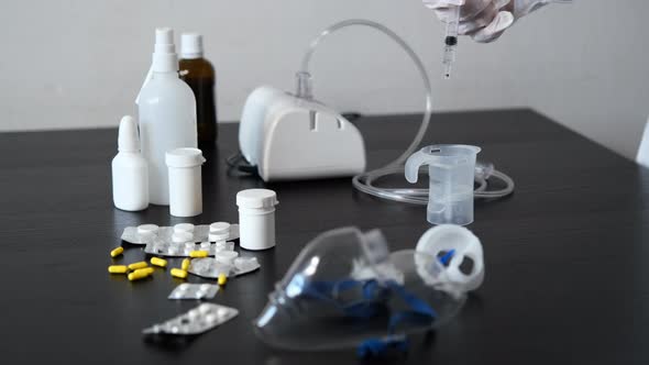 Hand of Doctor Preparing Medicine for Inhalation alt