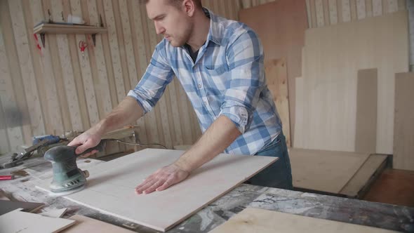 Carpenter Uses a Grinding Machine to Align