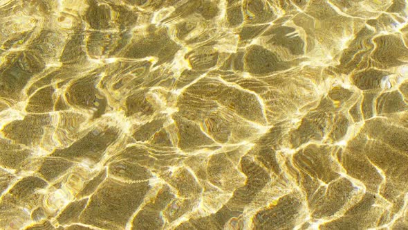 Crystal Clear Water Background Pure Ocean with Light Reflections in Slow Motion alt