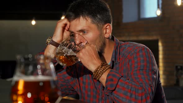 Depressed Man Drinking Alone at the Bar alt