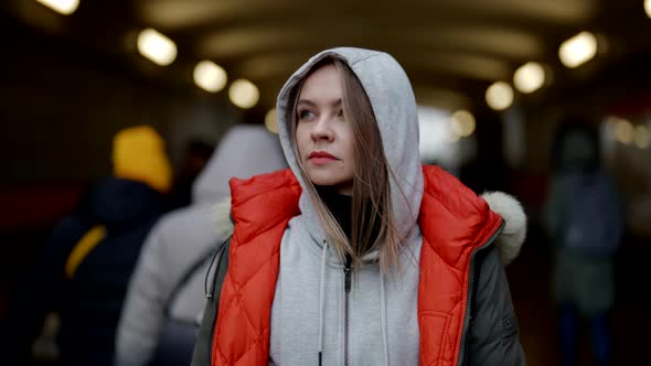 Young Woman in Megapolis Standing in Underground Entrance Medium Portrait Shot alt