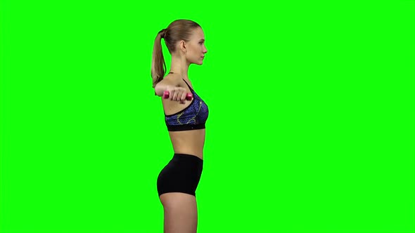 Girl with Dumbbells in Profile. Green Screen alt