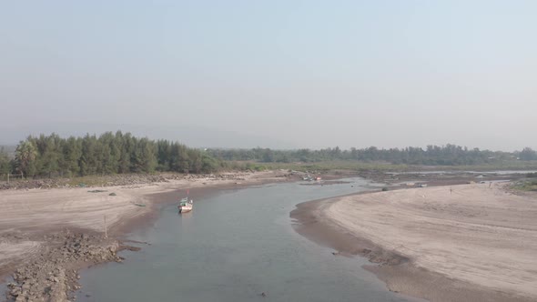 Aerial shot of small indian fishing boats on a tidal river nala alt