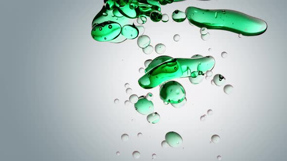 transparent cosmetic green blue oil bubbles and shapes on white background