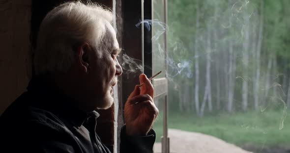 Sad Old Gray Haired Man Smokes Cigarette Sorrow and Sadness of the Old Man  60p Prores alt
