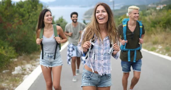 Group of Friends Backpackers Walking and Traveling Outdoor