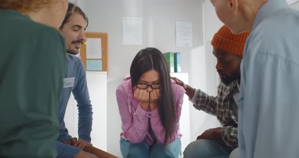 During Group Therapy Session Participants Supporting Crying Desperate Asian Woman alt