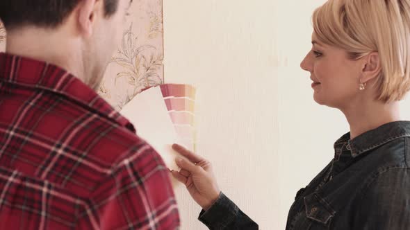 Adult Couple picking colours for home interior