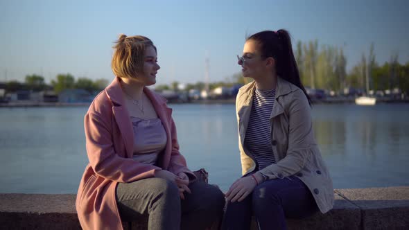 Women on Quay Outdoor Walking Talking Near the River Friendship Concept