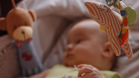 Newborn Baby Human Child Lies on His Back in a Stroller at Home alt