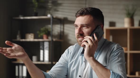 Stressed Young Man Hearing Awful News at Mobile Phone Call Conversation alt