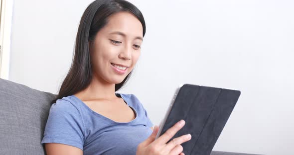 Woman using tablet computer at home  alt
