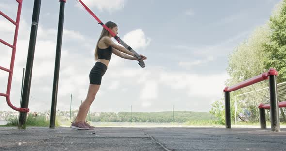 Beautiful Young Woman Does Training with Fitness Straps Outdoor, Attractive Female Training alt
