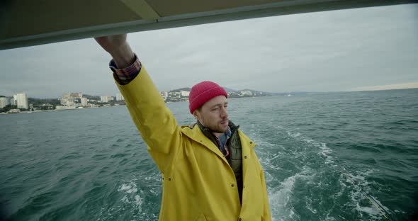 A Handsome Man Floats on the Ship and Looks Around