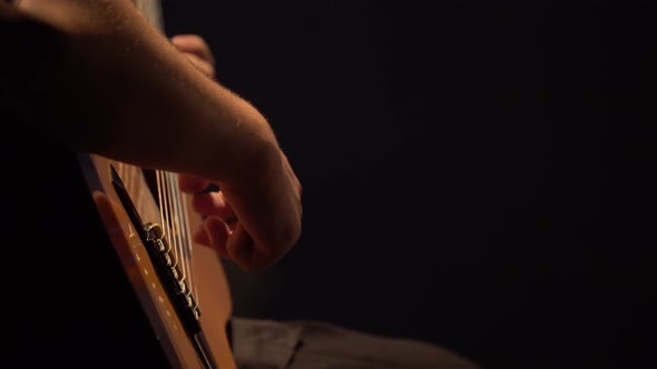 Male Guitarist Plays the Guitar in the Dark. Kyiv. Ukraine alt