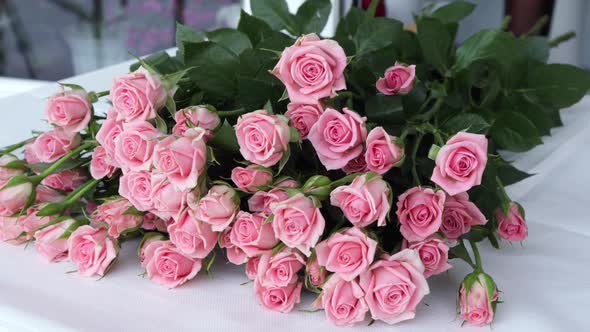 Close up florist hands working in flower shop studio.