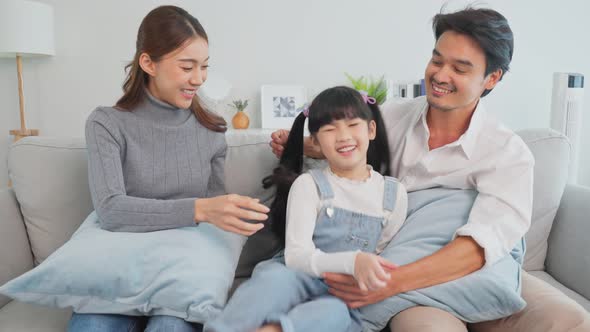 Portrait of Asian happy family enjoy spend time with kid together in house. alt