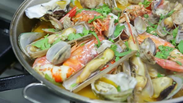 Cooking a Cataplan a Portuguese Dish with Organic Clean Seafood on Fire alt