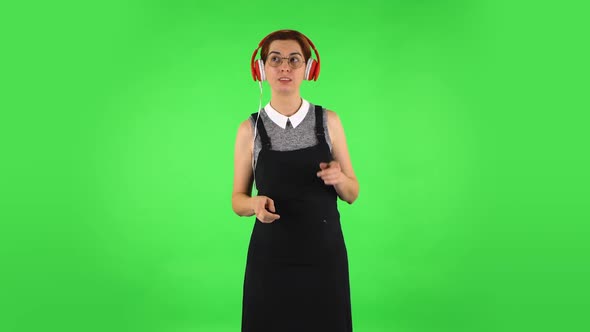 Funny Girl in Round Glasses Is Dancing and Enjoying Music in Big Red Headphones alt