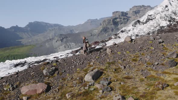 Travelling Man Hiking Down Rocky Hillside alt