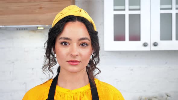 Close Up Serious Housewife Turns Head Looking Camera in Home Modern Kitchen alt