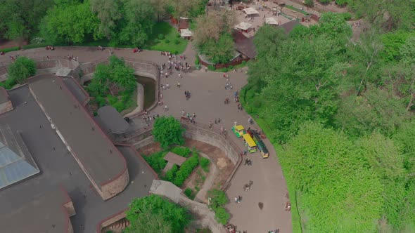Two Yellow Children's Trains are Riding in the Park Top View